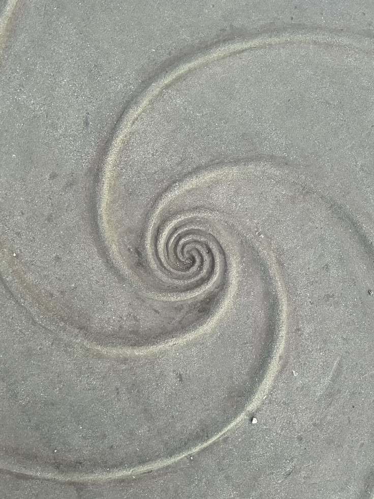 Spiral traced in wet sand